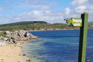 A photo of a sign to the Singing Sands